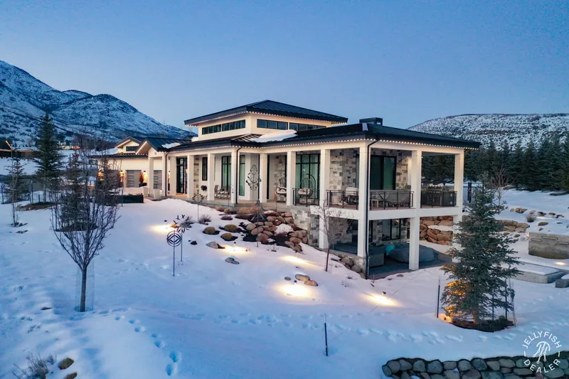 Warm-white permanent roofline lighting on a modern home